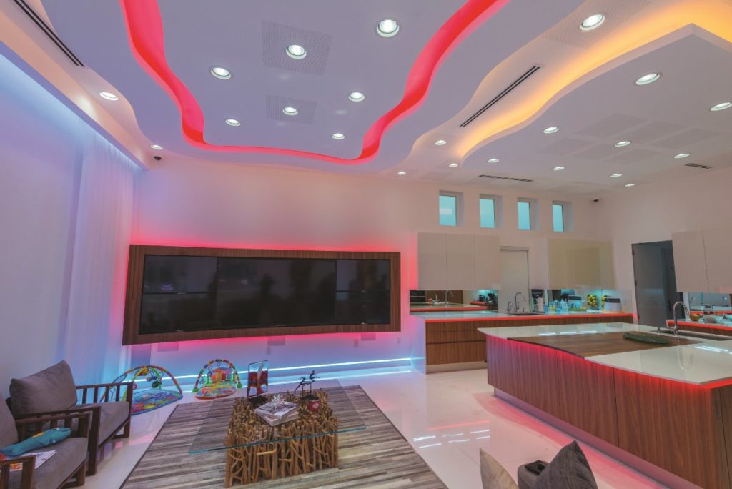 Colorful, pseudo-retro interior of Miami mansion using circadian lighting system.